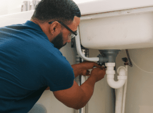 Plumber fixing sink