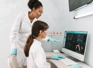 Dentists looking at x-rays on desktop computer