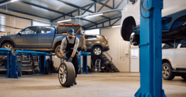 Auto repair professional replacing a tire on a car