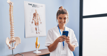 Chiropractor reviewing her Hibu dashboard on her mobile device