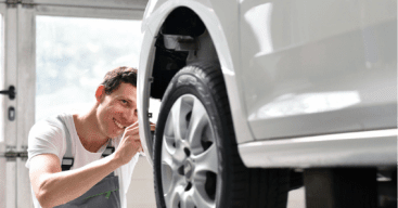 automotive professional working on white car